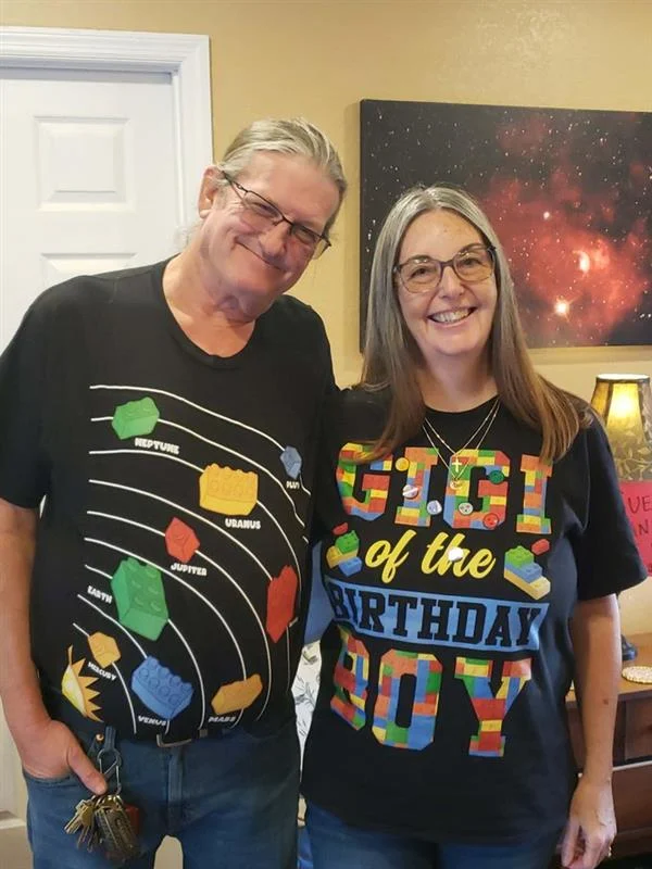 Ken and Tina Knorr smiling together in birthday shirts